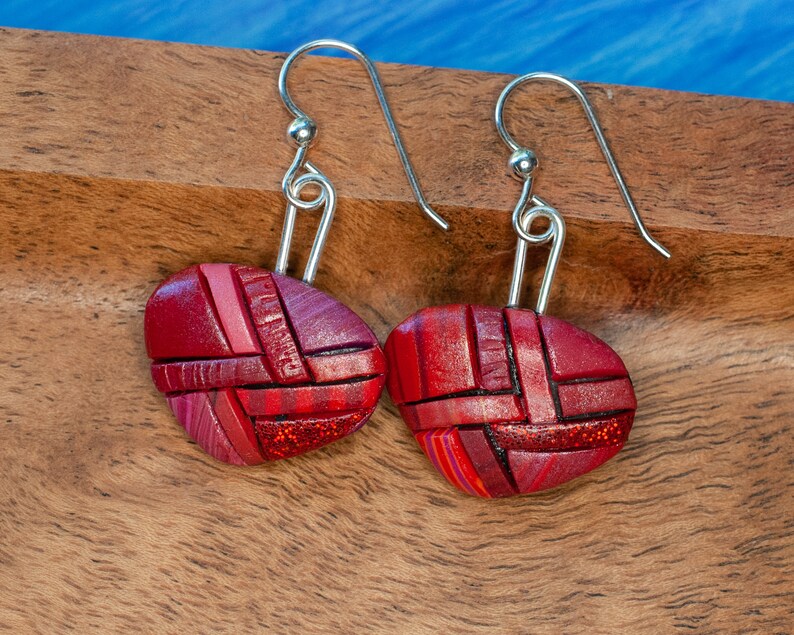 Photo shows bright red dangle mosaic earrings in an inverted triangle shape. The wires are shiny Sterling silver.
