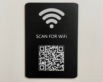 May include: A black rectangular card with rounded corners. The card features a white Wi-Fi symbol at the top, the text "SCAN FOR WiFi" in the middle, and a QR code at the bottom. The card is set against a white background.
