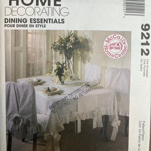 May include: A McCall's Home Decorating pattern for dining essentials, featuring a white tablecloth and chair covers with ruffles. The pattern number is 9212. The text "Fabricland Distributors No Refund No Returns" is printed on the pattern.
