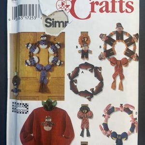 May include: A Simplicity Crafts sewing pattern for making a snowman, scarecrow, and bunny rabbit wreaths. The pattern includes instructions for making a snowman, scarecrow, and bunny rabbit ornaments. The pattern is for one size.