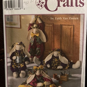 May include: A Simplicity Crafts sewing pattern for making four bunny doorstops. The pattern includes instructions for making a bunny with a watering can, a bunny with a hat, a bunny with a bow, and a bunny with a flower pot. The pattern is numbered 9430 and is priced at $10.00.