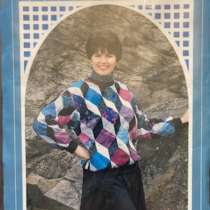 May include: A sewing pattern for a pullover sweater with a geometric design. The pattern is called "Tumbling Blocks Pullover" and includes sizes 6, 8-10, 12-14, 16-18, and 20-22.