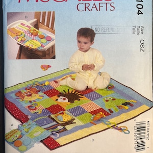 May include: A colorful baby play mat with a variety of textures and activities. The mat features a patchwork design with different animal characters, including a lion, a hedgehog, an owl, and a frog. The mat is surrounded by a brown border and has a variety of hanging toys, including rings, rattles, and a teether.
