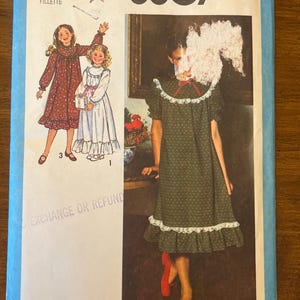 May include: Simplicity sewing pattern number 8807 for a girl's dress. The pattern includes instructions for making a dress with a lace trim and a gathered skirt. The pattern is for sizes 7 and 8.