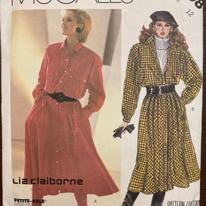 May include: A sewing pattern for a dress by Liz Claiborne. The pattern is for a petite size and includes two different styles. The first style is a red button-down dress with a long skirt. The second style is a yellow and black plaid dress with a long skirt. The pattern is for size 12.