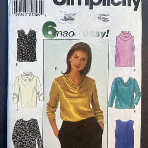 May include: Simplicity sewing pattern number 7884 for sizes Y 18, 20, and 22. The pattern includes instructions for making six different tops, including a sleeveless top with polka dots, a long-sleeved top with a cowl neck, and a sleeveless top with a scoop neck.