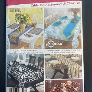 May include: A Simplicity sewing pattern for table top accessories, including a quilted runner, place mats, a mitered runner, a beaded runner, and a table cloth. The pattern number is 5530 and the title is "EASY! Table Top".