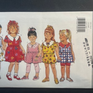 May include: A sewing pattern for five girls' dresses. The pattern is from the company Butterick and is for sizes 2-3, 3-4. The pattern is called "Fast & Easy Classics" and has a number of 4357.
