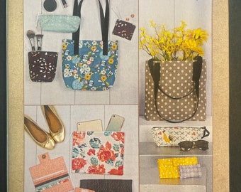 May include: A sewing pattern for bags and accessories. The pattern includes instructions for making a tote bag, a smaller bag, a zippered pouch, and a cosmetic bag. The pattern is printed on a brown paper background with a blue banner at the bottom that says "Bags and Accessories".