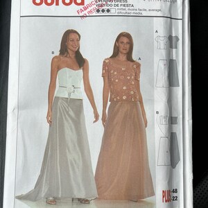 May include: Burda sewing pattern number 8467 for an evening dress. The pattern includes instructions for a strapless bodice and a long skirt with a train. The pattern is available in sizes 36 to 48.