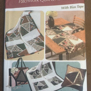 May include: A Simplicity home decorating pattern for patchwork quilts and accessories. The pattern includes designs for a quilt, pillow, tote bag, and table runner. The cover features images of the finished products, showcasing geometric patterns and various fabric combinations.