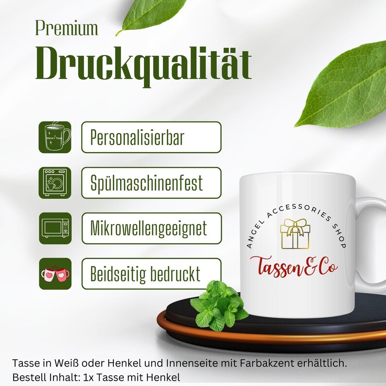 May include: White ceramic mug with a red and gold gift box design and the text "Angel Accessories Shop Tassen & Co". The mug is dishwasher, microwave, and personalisation safe. The mug is shown on a wooden coaster with a sprig of mint.