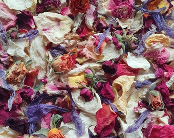 May include: A mix of dried flower petals in shades of pink, purple, white, and yellow. The petals are arranged in a random pattern and are perfect for crafting or decorating.