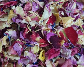 May include: A mix of dried flower petals in shades of pink, purple, yellow, and red. The petals are scattered randomly, creating a colorful and textured background.