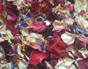 May include: A mix of dried rose petals in shades of pink, red, and white, with a few blue cornflower petals scattered throughout.