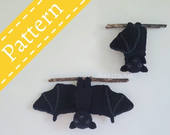 May include: Two black crocheted bats hanging from branches. The bats have large eyes and are made with black yarn. The bats are hanging upside down.