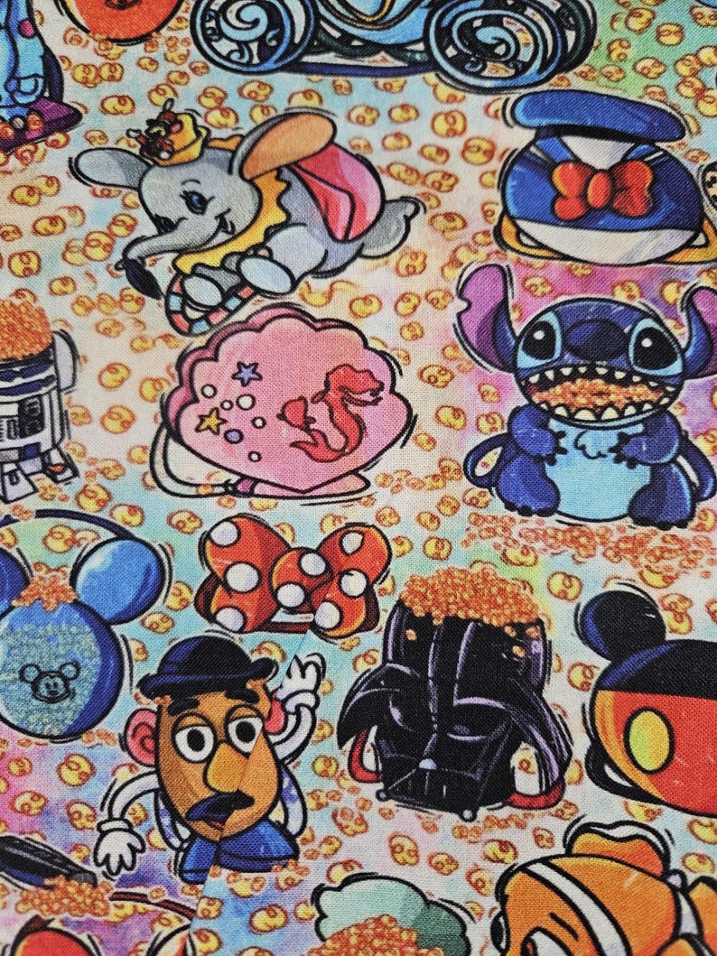 May include: A colorful fabric with a variety of Disney characters, including Mickey Mouse, Stitch, Darth Vader, and Dumbo. The fabric is covered in a pattern of small yellow circles.
