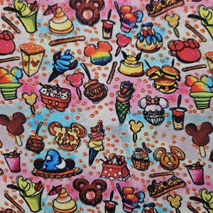 May include: A colorful fabric with a repeating pattern of various Disney-themed food items, including Mickey Mouse ears, ice cream cones, popcorn buckets, and pretzels. The background is a light blue and pink tie-dye pattern.