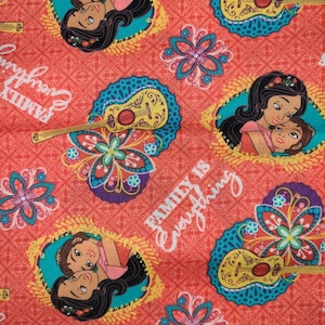 May include: A red fabric with a repeating pattern of a guitar, flowers, and two women with long dark hair. The text "Family is Everything" is repeated throughout the fabric.
