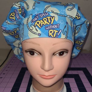 May include: A blue and yellow patterned scrub hat with the text "You can't spell party without RT!" repeated on the fabric.