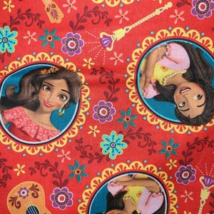 May include: Red fabric with a repeating pattern of a cartoon princess with brown hair and a yellow dress. The pattern also includes flowers, vines, and a guitar.