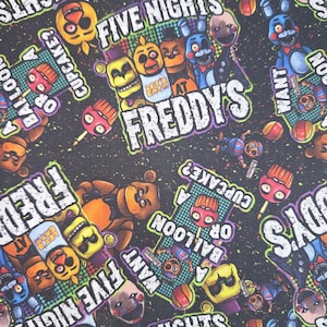 May include: A black fabric featuring a repeating pattern of characters and text from the video game "Five Nights at Freddy's." The design includes the game's logo, various character faces, and phrases like "Cupcake?" and "Want a Balloon?"