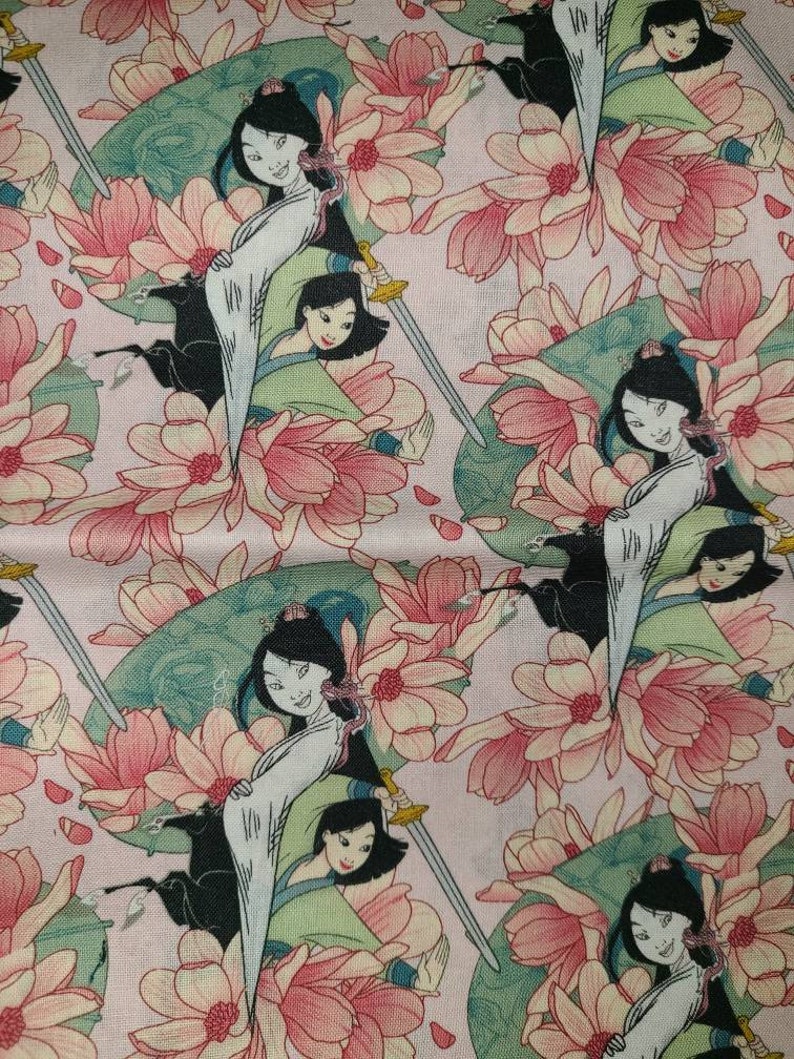 May include: A pink fabric with a repeating pattern of a woman in a white and green dress holding a sword. The woman is surrounded by pink flowers.