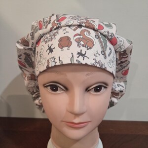 May include: A scrub cap featuring a festive holiday print on a light background. The pattern includes illustrations of squirrels wearing Santa hats, roasted turkeys, candy canes, and vintage trucks carrying Christmas trees in red, green, and brown.