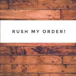 May include: A white button with the text "Buy it now" on a black background. The button is below a white rectangle with the text "RUSH MY ORDER!" on a brown wood background.