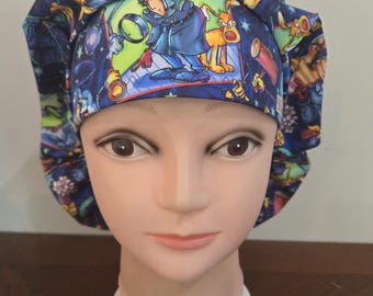May include: A scrub cap featuring a vibrant, multi-colored cartoon print of Inspector Gadget and his dog, Brain. The fabric displays various scenes of the characters in shades of blue, green, yellow, and red, with a gathered, pleated design.