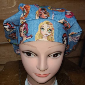 May include: A blue scrub hat with a print of Disney princesses with Day of the Dead makeup. The princesses include Rapunzel, Belle, and Ariel.
