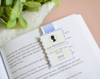 May include: A blue and white bookmark with a silhouette of a woman's head and the text "Lady Whistledown Spilling the Tea Since 1813".