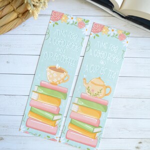 May include: Two colourful bookmarks featuring a stack of books, flowers, and a cup of coffee on one and a teapot on the other. The text on the bookmarks reads "Time for a good book and a cup of coffee" and "Time for a good book and a cup of tea".
