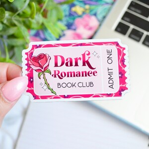 May include: A pink and white ticket with a rose illustration and the text 