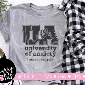 May include: A gray t-shirt with a black graphic that says "UA University of Anxiety Honors Program".