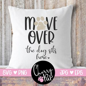 May include: White pillow with black text that reads "Move Over The Dog Sits Here" with a paw print graphic. The pillow is on a wooden background. The text "Cherry Pup" is in a black circle with a pink paw print.