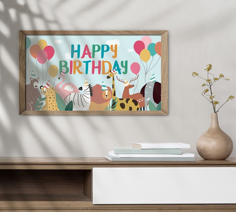 May include: A framed print with a blue background featuring the text "Happy Birthday" in colorful letters. The print also includes a group of animals wearing party hats and surrounded by balloons.