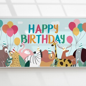 May include: A colorful banner with the text "Happy Birthday" and a variety of animals including a zebra, giraffe, flamingo, lion, deer, elephant, and bear. The banner is decorated with balloons in shades of pink, red, yellow, and blue.