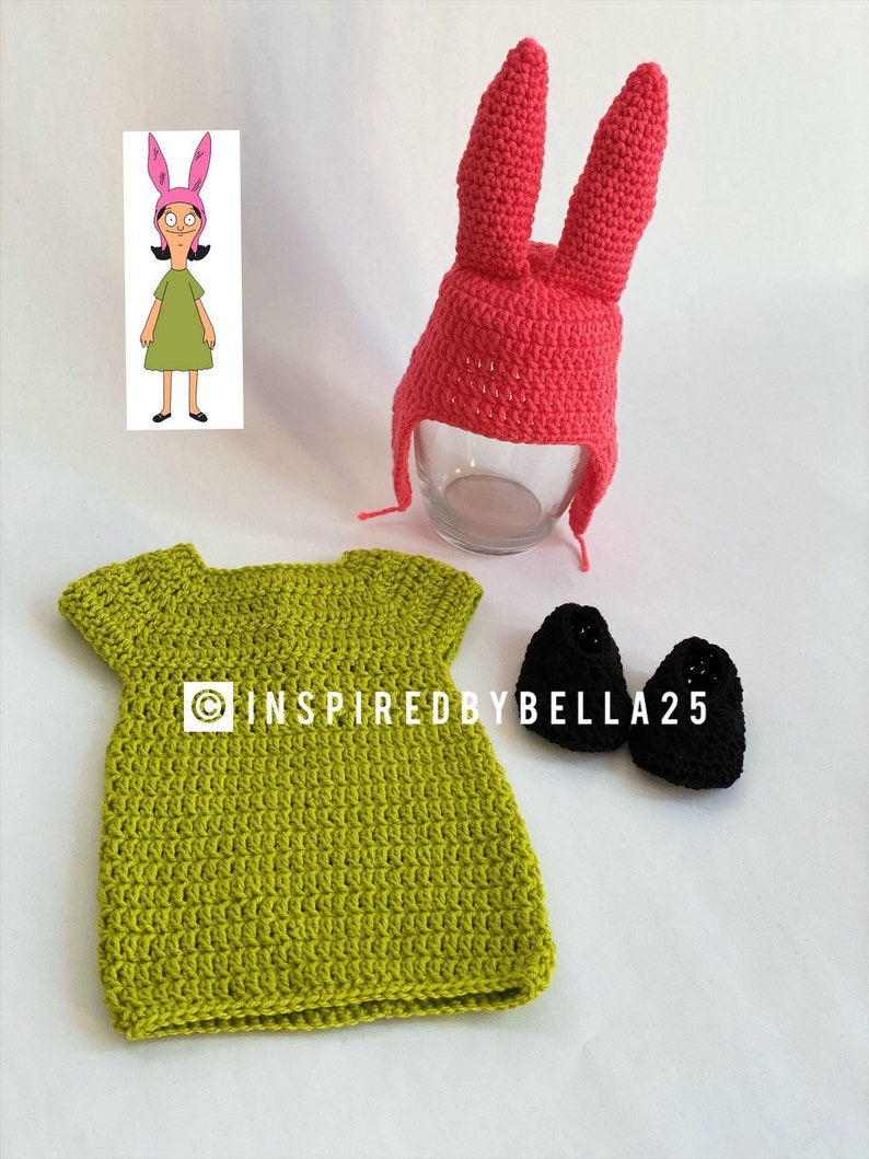 May include: A crochet outfit inspired by the character BoJack Horseman's daughter, Hollyhock. The outfit includes a green dress, a pink bunny hat with long ears, and black crochet shoes.