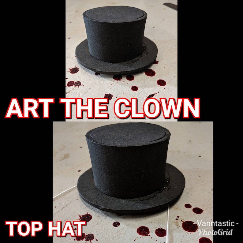 May include: A black top hat with a wide brim, sitting on a white surface with red splatters. The text "ART THE CLOWN" is above the hat and "TOP HAT" is below the hat.