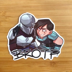 K&ouml;nnte beinhalten: Ein Aufkleber mit einer Cartoon-Illustration eines Mandalorians und einer weiblichen Figur mit dem Wort "BROTP" darunter.