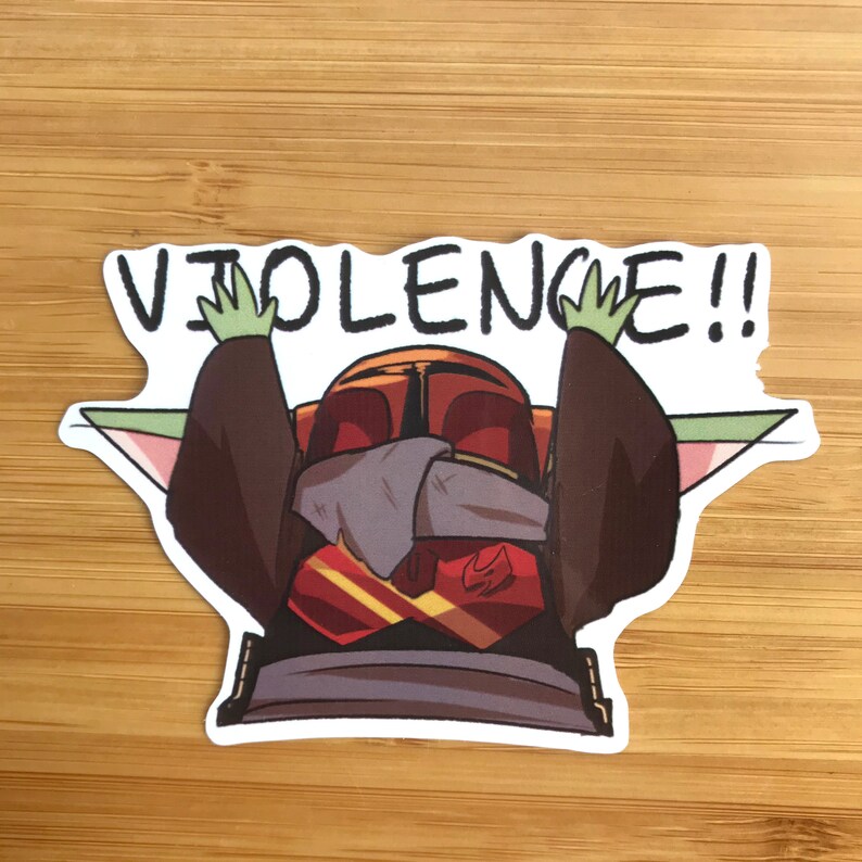 K&ouml;nnte beinhalten: Ein Aufkleber mit einer Comicfigur mit gr&uuml;ner Haut und gro&szlig;en Ohren, die ein rot-goldenes Outfit tr&auml;gt. Die Figur h&auml;lt beide H&auml;nde hoch und der Text "VIOLENCE!!" befindet sich &uuml;ber der Figur.