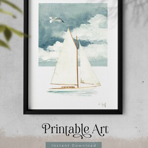May include: A watercolor painting of a sailboat with white sails against a blue sky with white clouds. A seagull flies above the boat. The painting is framed in black.