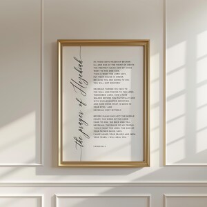 May include: A framed print with a gold-colored frame. The print features elegant calligraphy text in black, titled "the prayer of Hezekiah," and includes a passage from the Bible. The background is white.