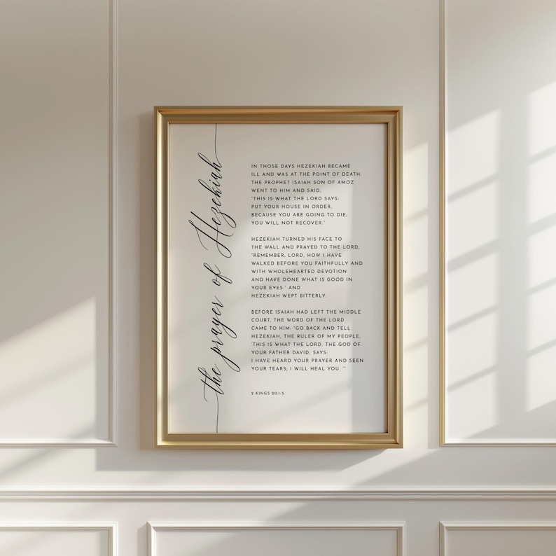 May include: A framed print with a gold-colored frame. The print features elegant calligraphy text in black, titled "the prayer of Hezekiah," and includes a passage from the Bible. The background is white.