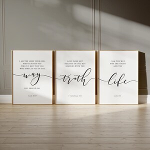 May include: Three framed art prints with gold frames. Each print has a white background with black cursive text. The text includes the words "way", "truth", and "life", along with Bible verses.