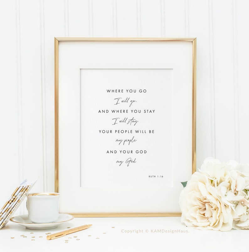 May include: A framed print with a gold frame and a white background. The print features a quote from the Bible, Ruth 1:16, which reads: "Where you go I will go, and where you stay I will stay. Your people will be my people and your God my God."