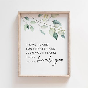 May include: A white framed print with a watercolor illustration of eucalyptus leaves. The print features the text "I have heard your prayer and seen your tears; I will heal you" and the scripture reference "2 Kings 20:5".