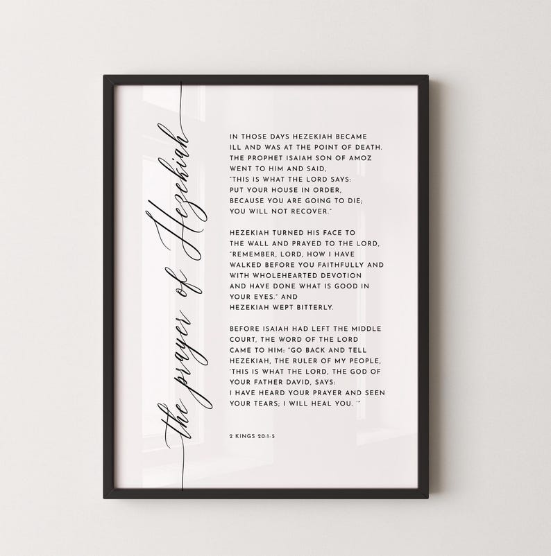 May include: A framed print with the text "the prayer of Hezekiah" in elegant script. The print features a passage from 2 Kings 20:1-5, printed in black on a white background. The frame is black.