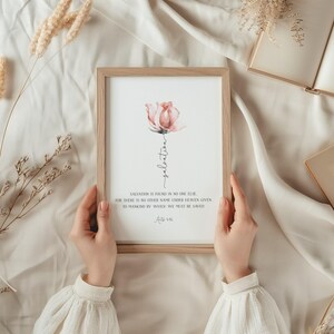 May include: A framed print with a watercolor painting of a pink rose and the text "salvation is found in no one else for there is no other name under heaven given to mankind by which we must be saved Acts 4:12"